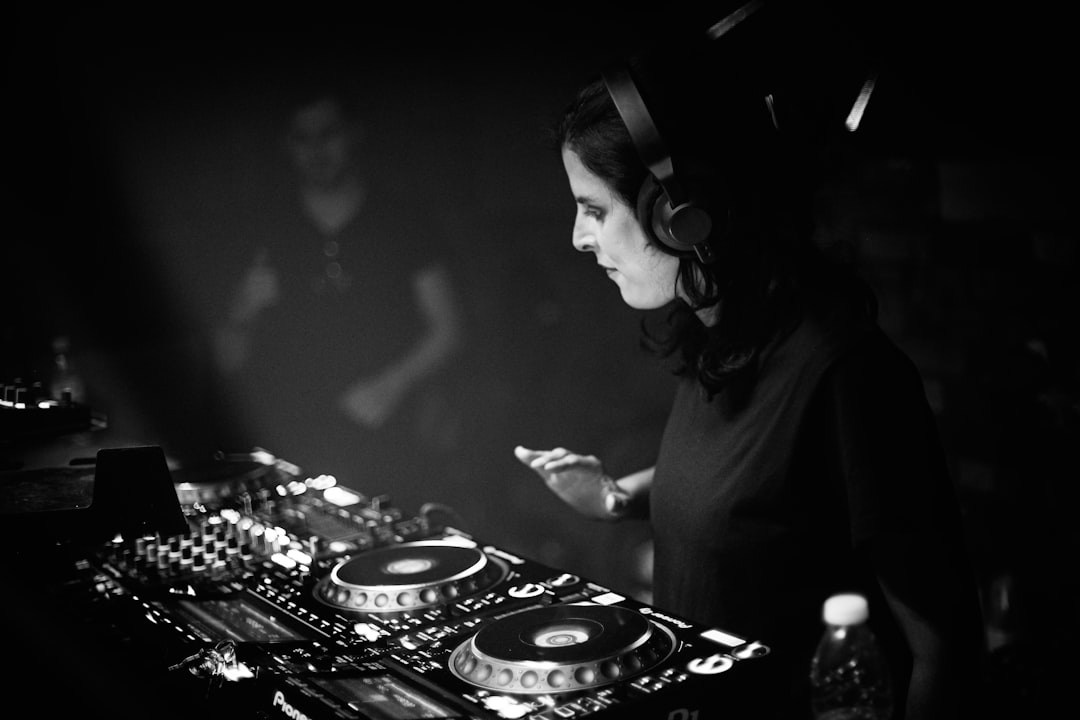 A dj mixing music in a dark room