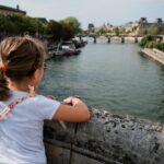 A little girl looking out over a river