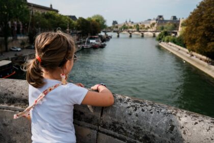 A little girl looking out over a river
