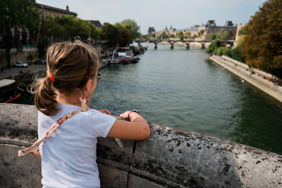 A little girl looking out over a river
