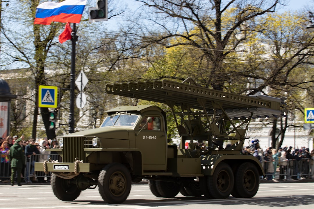 A russian military vehicle parades in the street.