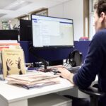 Man working at a computer in an office.