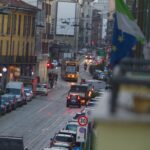 Street scene with tram and cars in european city.