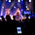 people taking videos during concert