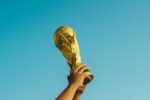 person holding gold trophy