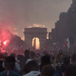 people gathering near arch gate