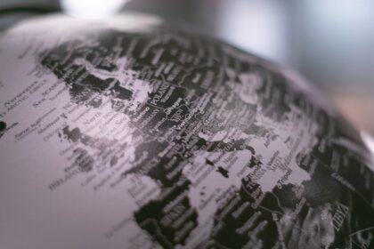 grayscale photo of desk globe