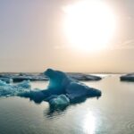 a large iceberg floating in the middle of a lake