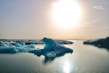 a large iceberg floating in the middle of a lake