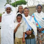 a group of women standing next to each other