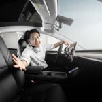 a man sitting in a car with headphones on