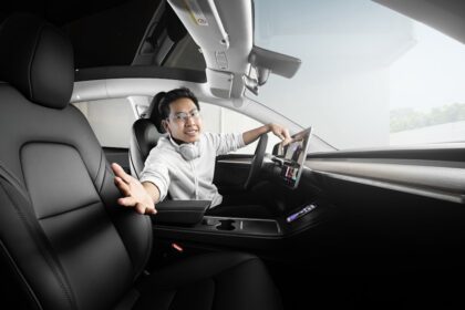 a man sitting in a car with headphones on