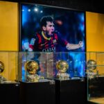 a person standing behind trophies