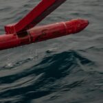 a red pipe sticking out of the water