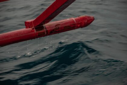 a red pipe sticking out of the water