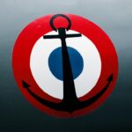 a red, white and blue sign with an anchor on it