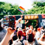 a group of people taking pictures with their cell phones