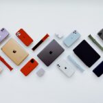 a group of different colored cell phones sitting next to each other