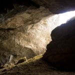 a cave with a light coming through it