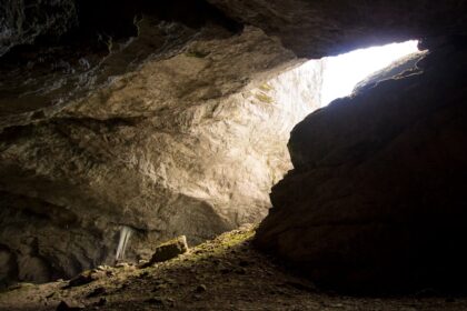 a cave with a light coming through it