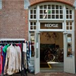 Recycle center with clothes and bicycles inside.