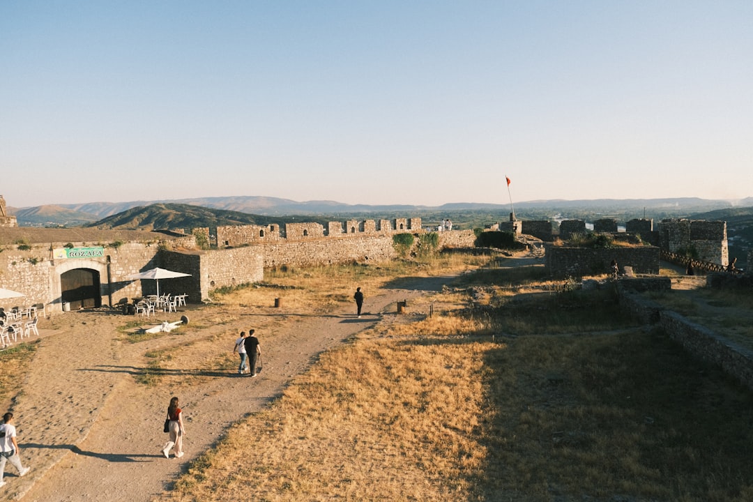 Ancient stone fortress ruins under a clear blue sky.