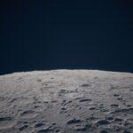 Cratered lunar surface against a dark sky