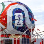 A giant colorful fifa soccer ball structure with canadian flags.