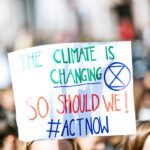 person holding The Climate is Changing signage