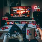 a person holding a cup and a game controller in front of a television