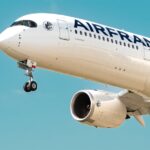 a large airfrance jet flying through a blue sky