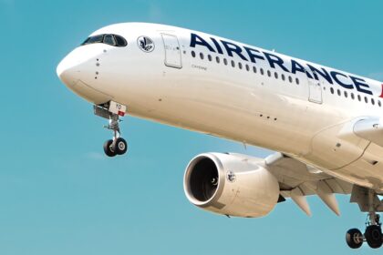 a large airfrance jet flying through a blue sky
