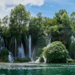 a large waterfall in the middle of a body of water