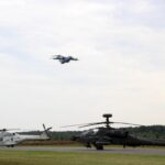 A helicopter and a helicopter on a runway