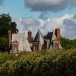 A beautiful house is nestled among lush greenery.
