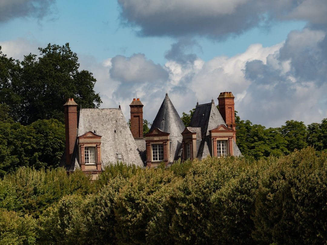 A beautiful house is nestled among lush greenery.
