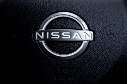 Close-up of a nissan car steering wheel logo.