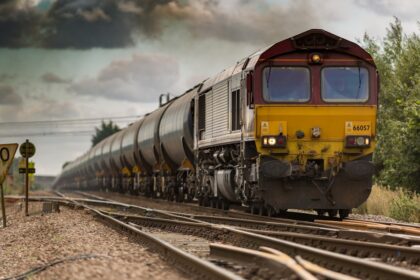 yellow and black train on railways