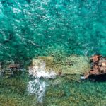 aerial photography of abandoned boat in body of water during daytime