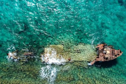 aerial photography of abandoned boat in body of water during daytime
