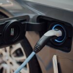 electric vehicle charging cable plugged into car