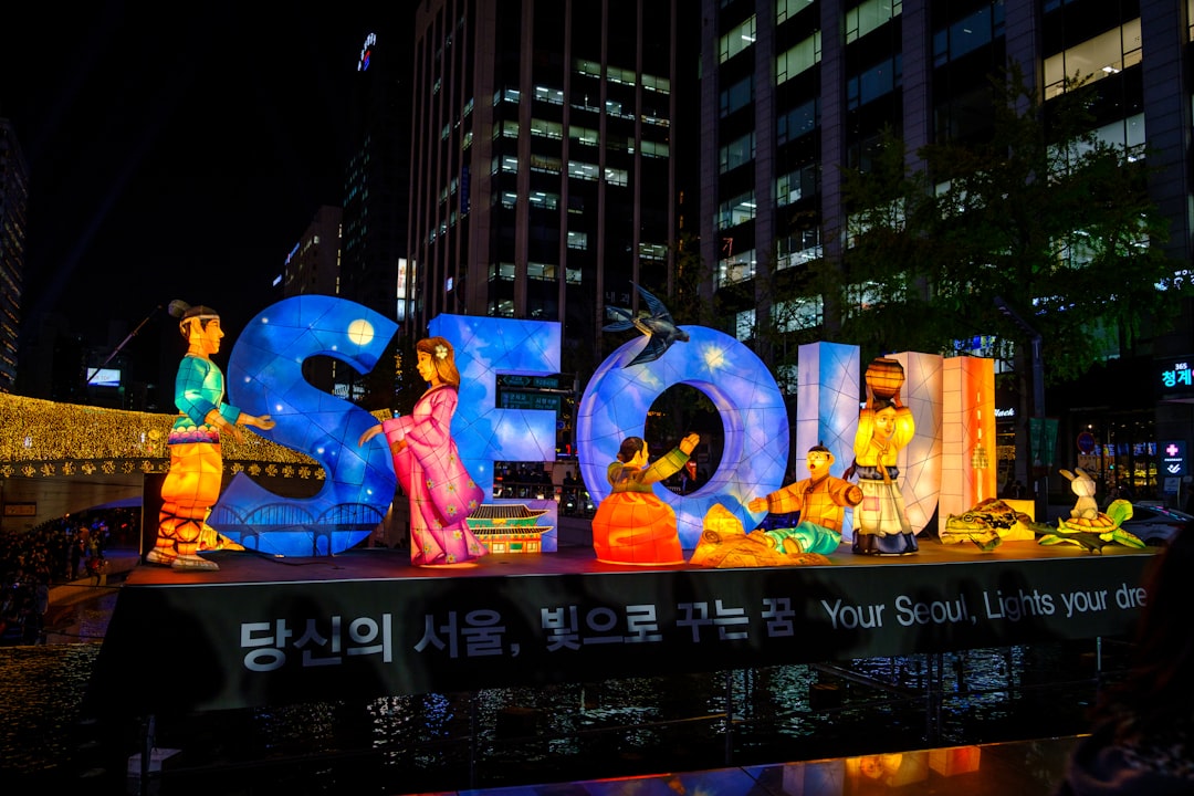 Illuminated figures and large letters spelling SEOUL at the Seoul Lantern Festival at night