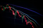 stock market candlestick chart on dark screen