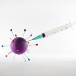 white and green syringe on white surface