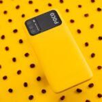 black samsung android smartphone on yellow and white polka dots textile