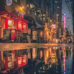 a city street with a puddle in the middle of it