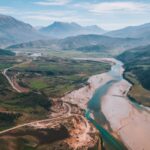 an aerial view of a river running through a valley