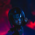 a close up of a doll with a red light in the background