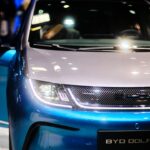 a close up of the front of a blue and white car