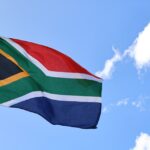 a flag flying in the wind on a sunny day